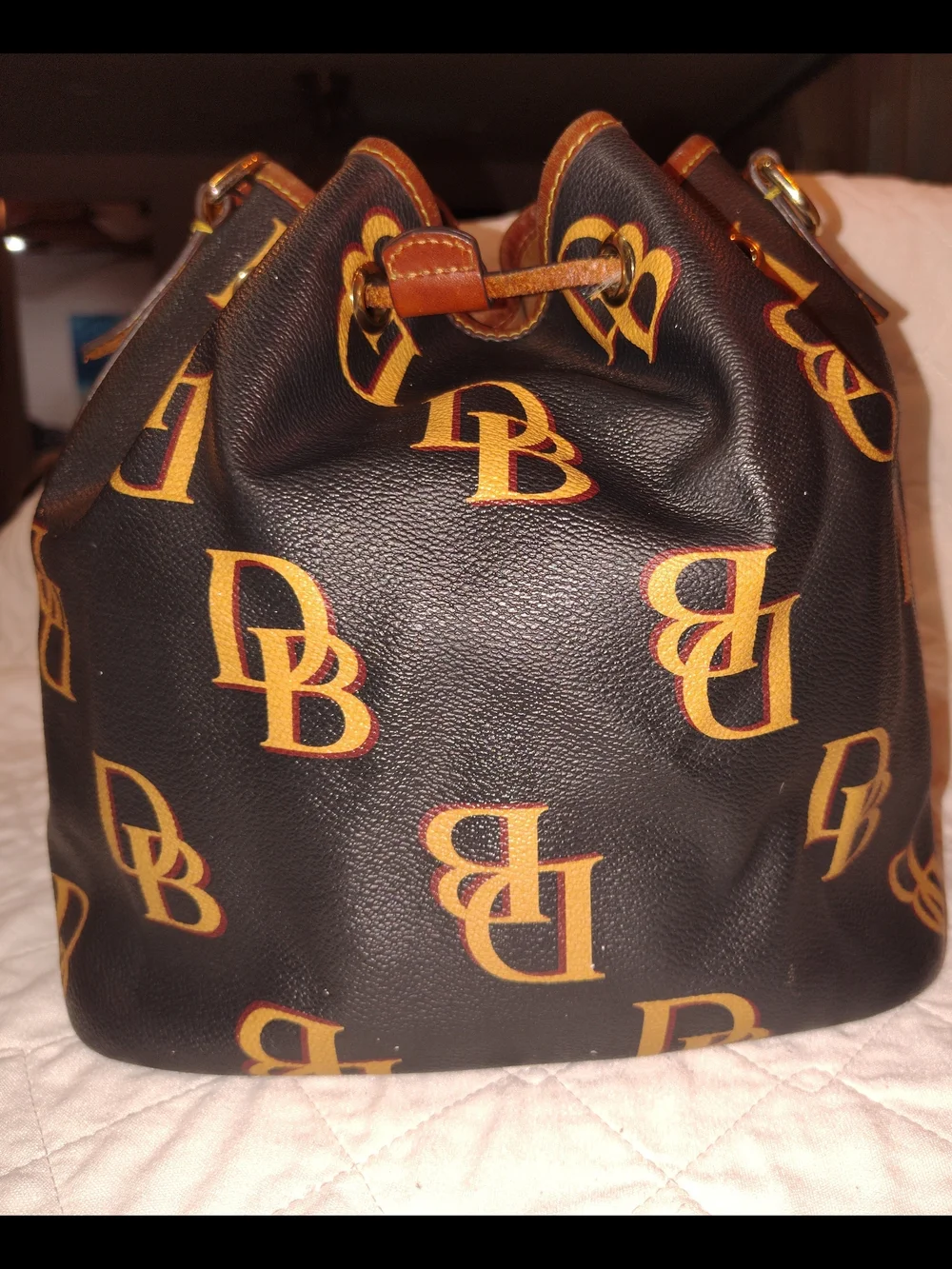 Dooney & Bourke Black and Tan Monogram Drawstring Bucket Bag